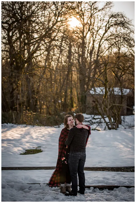 Engagment photo session of a couple taken in trees and snow at Dorris Ranch in Oregon