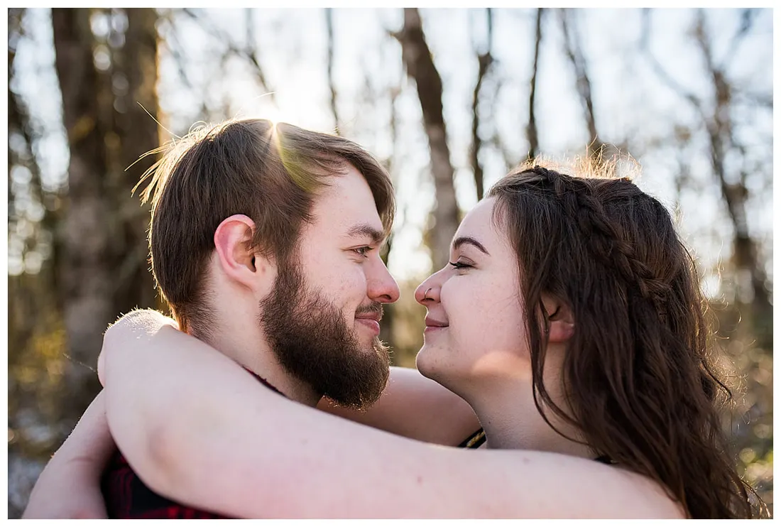 Engagment photo session of a couple taken in trees and snow at Dorris Ranch in Oregon