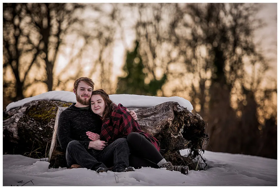 Engagment photo session of a couple taken in trees and snow at Dorris Ranch in Oregon