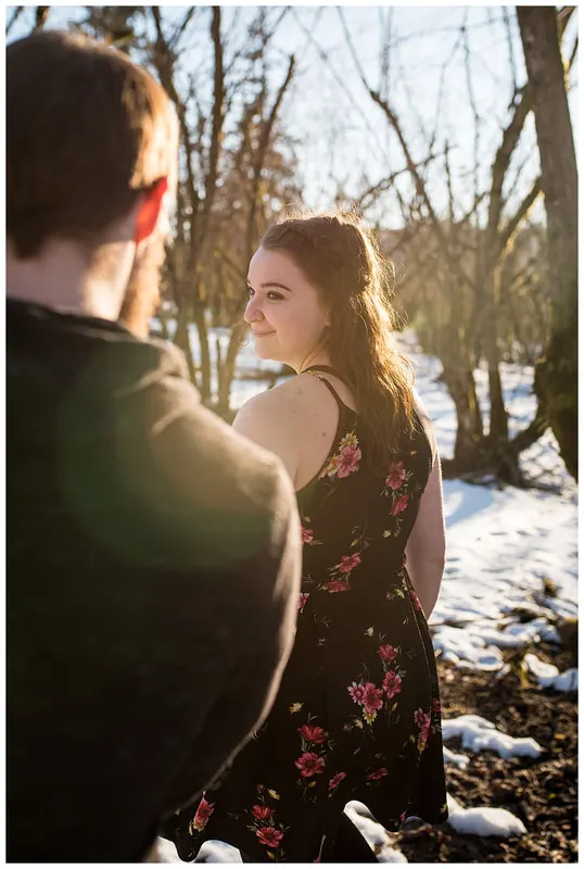 Engagment photo session of a couple taken in trees and snow at Dorris Ranch in Oregon