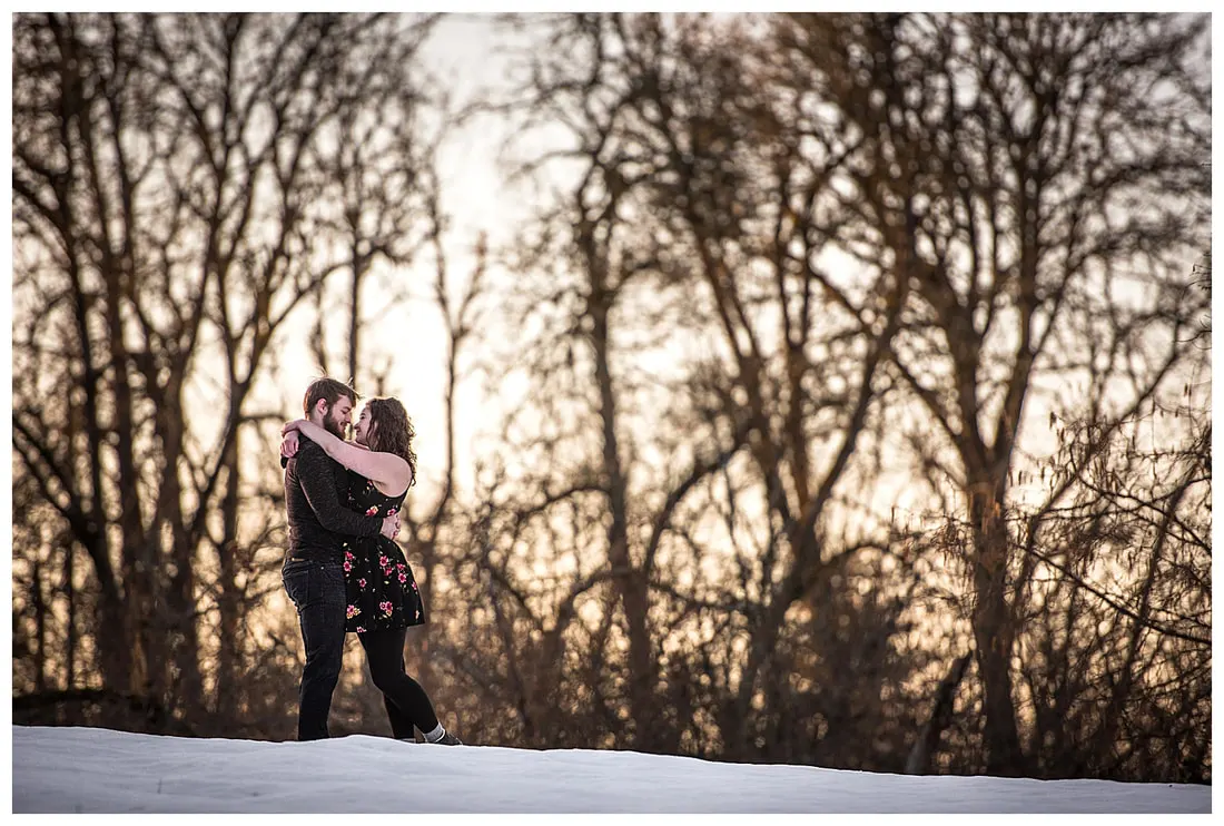Engagment photo session of a couple taken in trees and snow at Dorris Ranch in Oregon