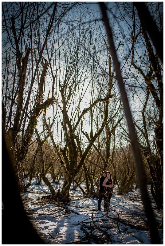 Engagment photo session of a couple taken in trees and snow at Dorris Ranch in Oregon