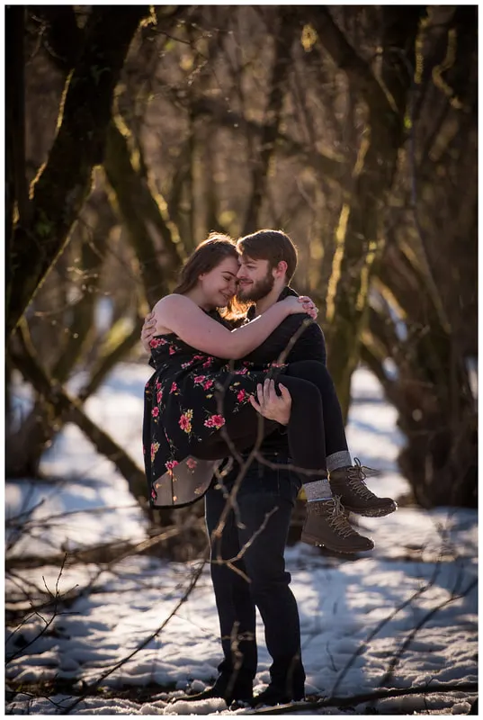 Engagment photo session of a couple taken in trees and snow at Dorris Ranch in Oregon
