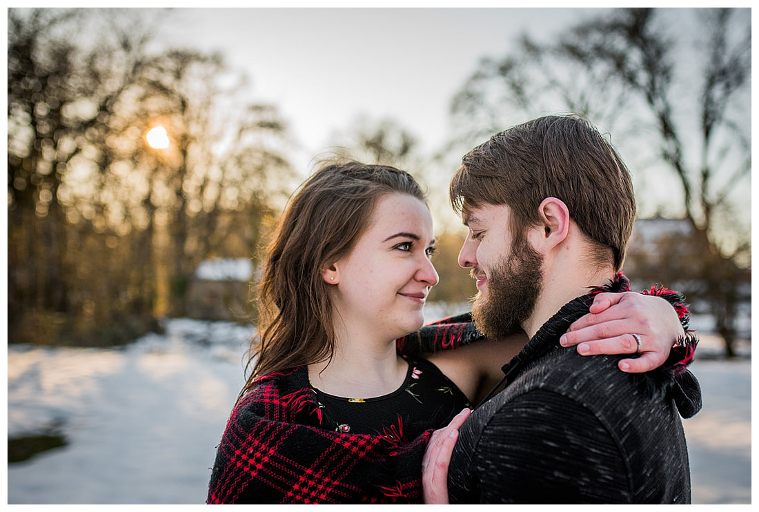 Engagment photo session of a couple taken in trees and snow at Dorris Ranch in Oregon