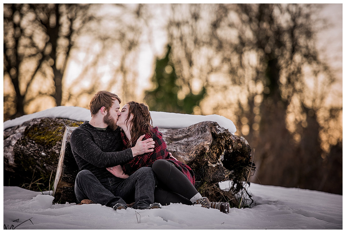 Engagment photo session of a couple taken in trees and snow at Dorris Ranch in Oregon