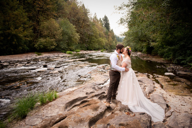 Wedding photography of bride & groom along a river at Camp Lane, Oregon